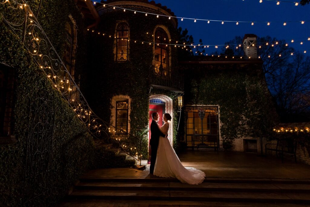 Dramatic evening shot of back lit bride and groom at blue light hour