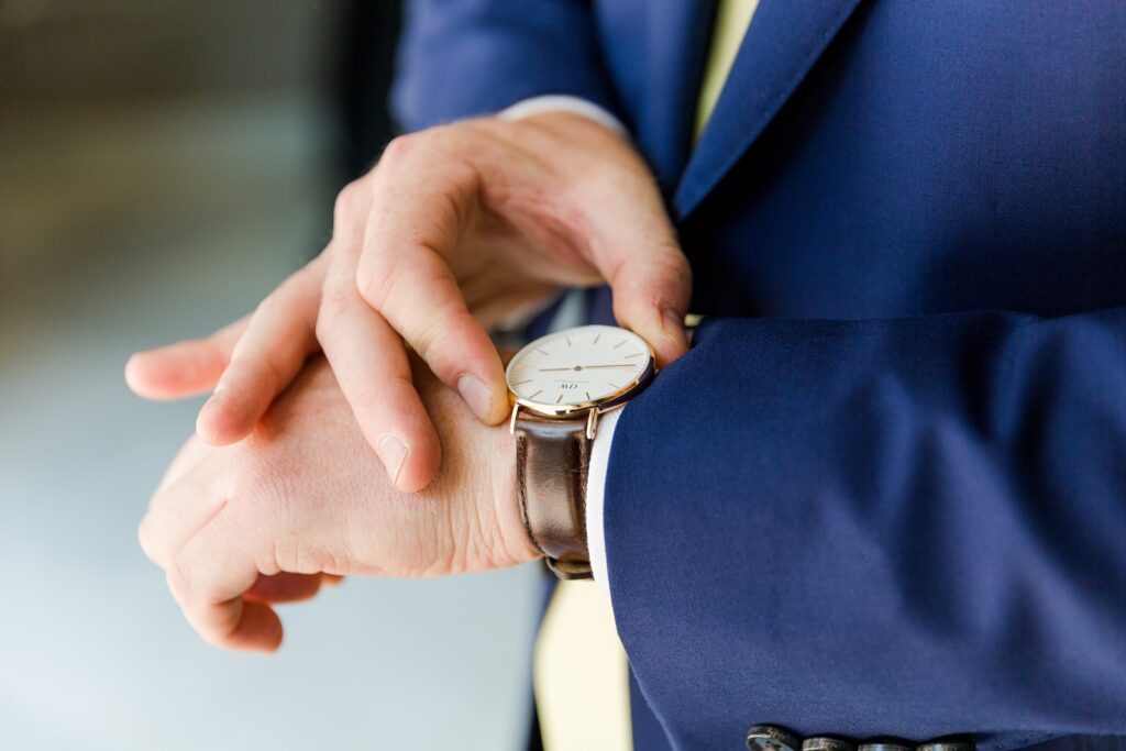 Groom looking at new watch on his wrist