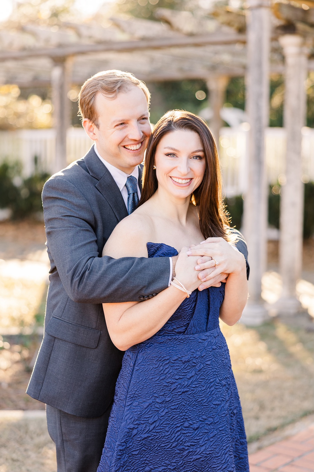 Couple smiling during golden hour engagement session at the Birmingham Botanical Gardens