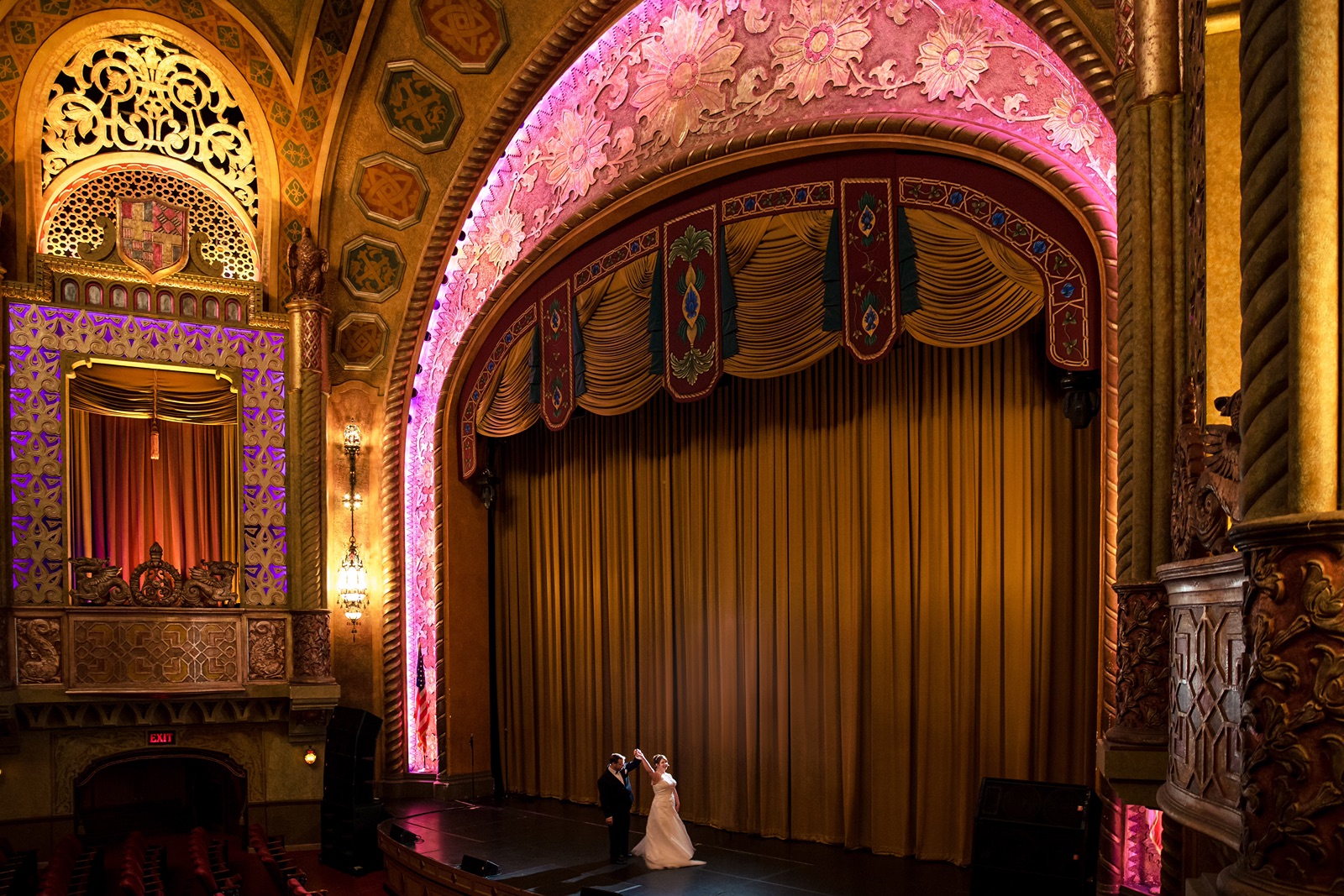 Bride and groom dancing on the state at the historic Alabama Theatre in Birmingham, Alabama