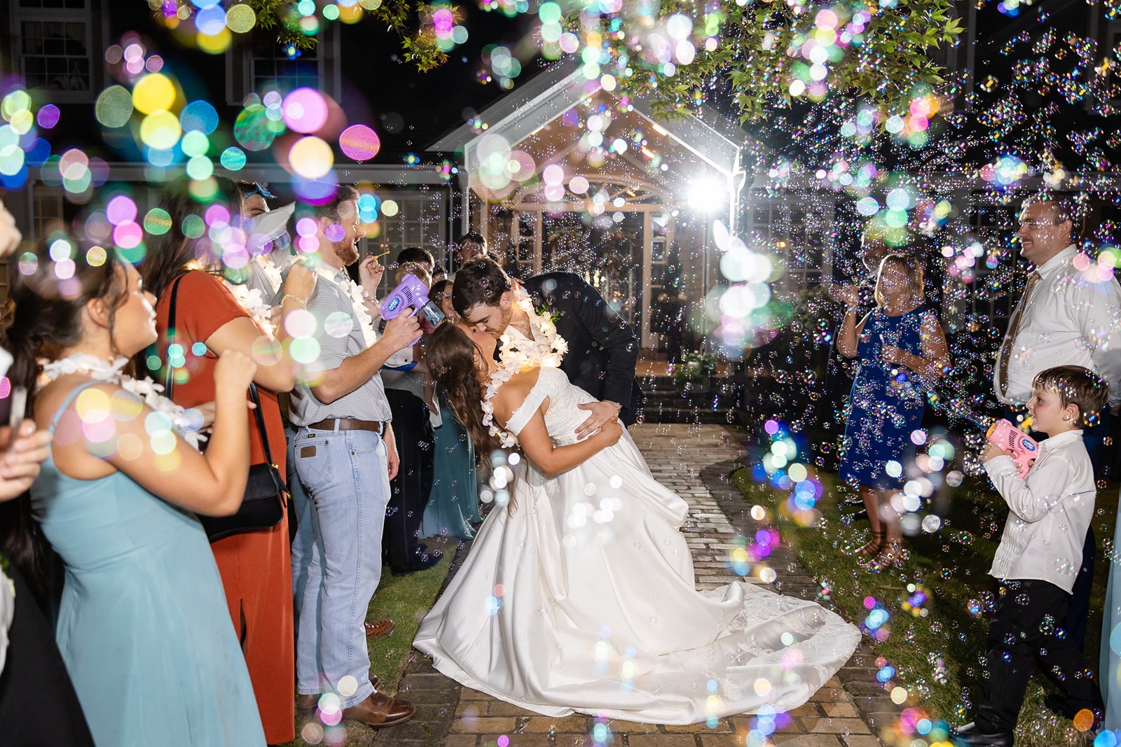 Groom dipping bride during their bubble sendoff.